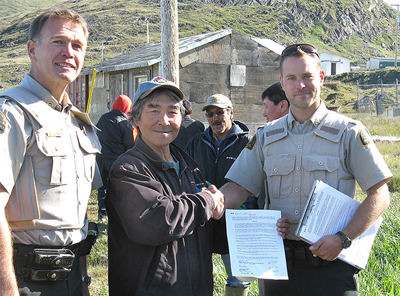 Aquuijaq Qisiiq from Nunavik receives a community fishing permit from Fisheries and Oceans Canada officers.