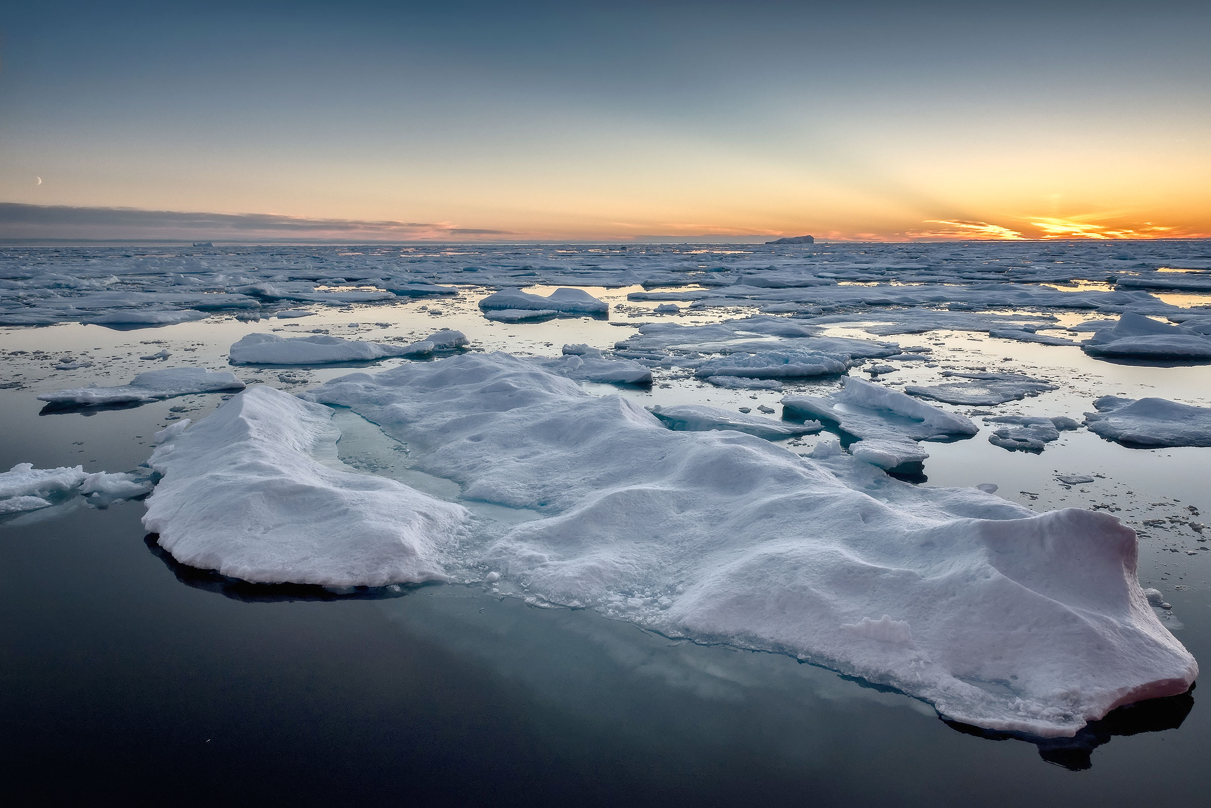 Sunset over ice-covered ocean