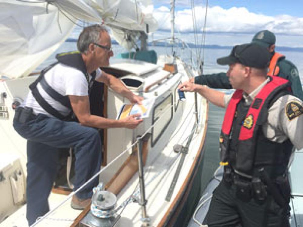 Two officers addressing a recreational boater