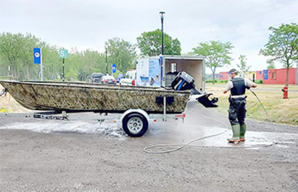 A fishery officer cleaning a boat